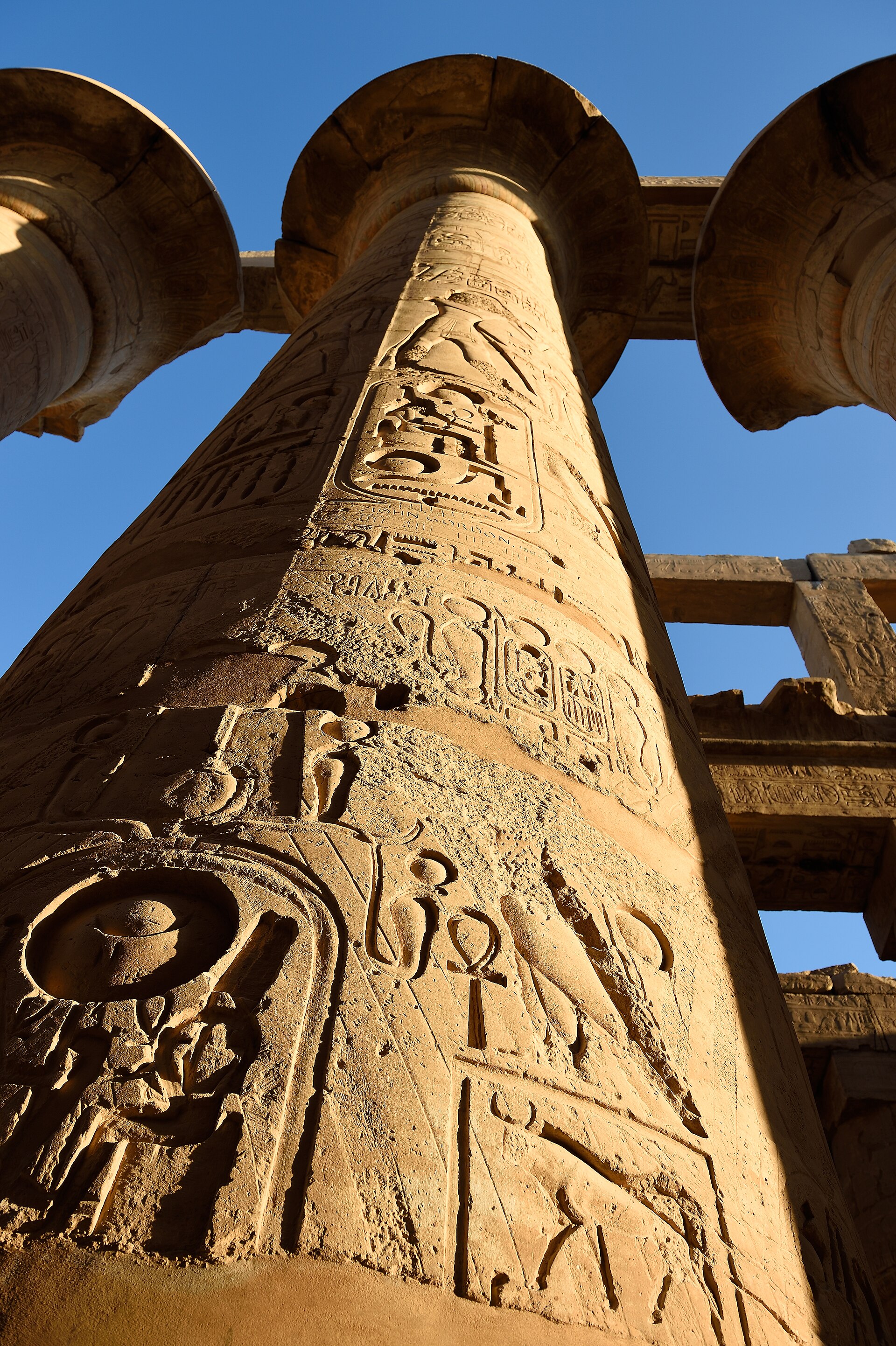 Hieroglyphs on a Karnak column against blue sky